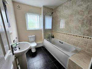 a bathroom with a sink and a tub and a toilet at Baltic Townhouse, 4 Bed, Parking - Pass the Keys in Liverpool