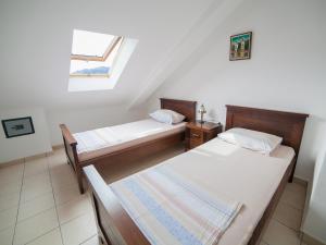 a room with two beds and a window at Apartments Stone House in Tivat