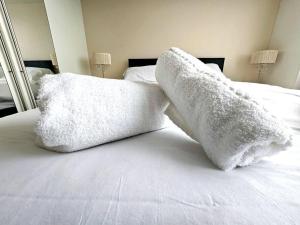 two white pillows sitting on top of a bed at Baltic Townhouse, 4 Bed, Parking - Pass the Keys in Liverpool