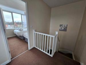 a room with a staircase with a bed and a window at Baltic Townhouse, 4 Bed, Parking - Pass the Keys in Liverpool