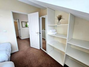 a room with white shelves and a bed at Baltic Townhouse, 4 Bed, Parking - Pass the Keys in Liverpool