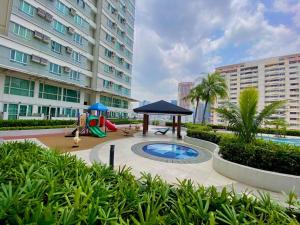 a courtyard with a playground and a play area at Makati Penthouse with Stunning City Skyline View in Manila