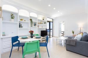 a living room with a table and chairs and a couch at Home2Book Casa Malena Tabaiba Seaview in Tabaiba +35 photos