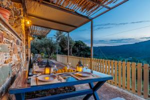 a blue table on a patio with a view at Villa Maja in Skopelos Town