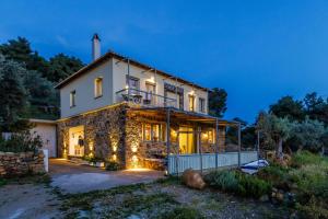 a stone house with lights on it at night at Villa Maja in Skopelos Town