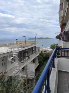 a view of the ocean from the balcony of a building at Theodora's Bay View Apartment in Nea Peramos