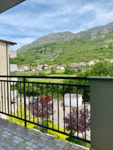 a balcony with a view of a parking lot at Apartment 28 in Ljubuški