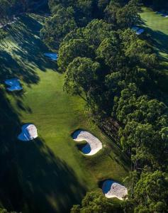 an overhead view of a golf course with two holes at The Arcadia - Entire Luxurious English Cottage With Huge Privacy Near CBD in Springfield Lakes