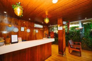 a lobby with a counter and a chair at Cygnett Inn Celestiial Goa in Candolim
