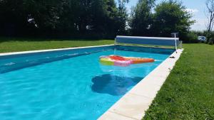 a swimming pool with a life preserver in the water at De terre et de bois. 