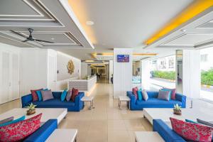 a lobby with blue couches and tables in a building at Best Western Patong Beach in Patong Beach