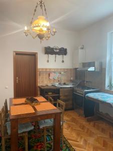 a kitchen with a table and a dining room at Casa Toma M in Baia Mare