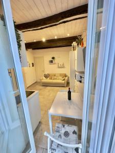 a kitchen and a living room with a white table at La Terrazza sul Mare [ ☆☆☆☆☆ ] Monterosso in Monterosso al Mare