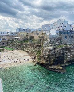 a group of people on a beach near the water at Casa della Luna in Bari