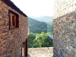 a view from the side of a stone building at Moinhos do Paiva in Castelo de Paiva