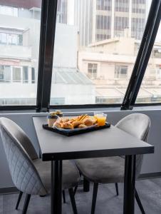 a tray of food sitting on a table in front of a window at Olvia Suites in Athens