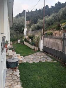 a backyard with a stone yard with a fence at White Hill Platanos in Akrata