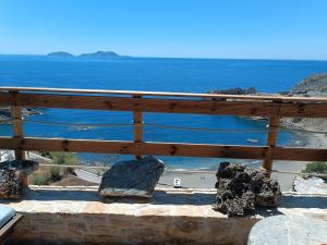 a view of the ocean from a balcony at Vila Apostolis in Agios Pavlos