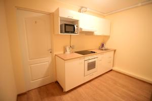 a small kitchen with a sink and a microwave at Varpo st 10 Kaunas Students Home LT in Kaunas