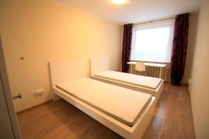 two beds in a small room with a window at Varpo st 10 Kaunas Students Home LT in Kaunas