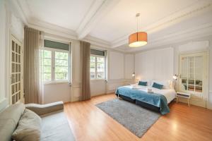 a large bedroom with a bed and a couch at Feel Porto Downtown Apartments & Studios in Porto
