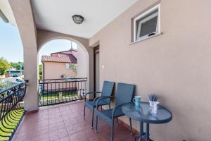 patio con mesa y sillas en el balcón en Apartments Morena, en Novigrad Istria