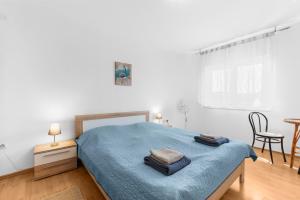 1 dormitorio con 1 cama con 2 toallas en Apartments Morena, en Novigrad Istria