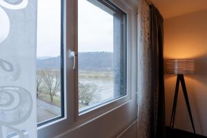 a window with a view of a river at FourSide Hotel Trier in Trier