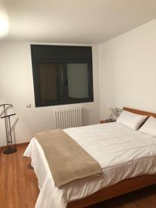 a bedroom with a large white bed with a window at Residencial Sol i Ski 23 4p Ransol El Tarter Zona Grandvalira in El Tarter