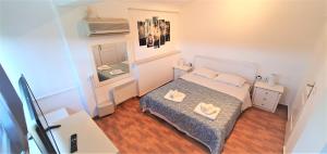 a small bedroom with a bed and a mirror at Vacation and Relaxation Home Oropos in Néa Palátia