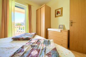 a bedroom with two beds and a window at Apartment Henrik in Krk