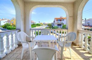 a white table and chairs on a balcony at Apartment Henrik in Krk
