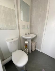 a bathroom with a white toilet and a sink at Moonstone in Beadnell