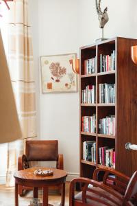 a room with a table and a book shelf with books at Hôtel La Villa Cap d’Antibes in Juan-les-Pins