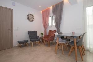 a dining room with a table and chairs at Anthi Beach Suite in Zakynthos Town