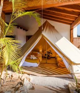 a bedroom with a bed in a tent at Slow Axarquía in Torre de Benagalbón