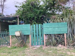 a blue fence with a sign that reads at Alba Luz in La Paloma