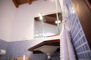 a bathroom with a sink and a mirror at Slow Axarquía in Torre de Benagalbón +12 photos