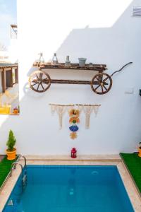 a house with a swimming pool and a wagon on the wall at 7 Art Feslegen Hotel By Egeos in Bodrum City