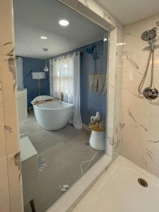 a bathroom with a bath tub and a tub at Lucky Stone Retreat - private beach & Acadia view in Sullivan