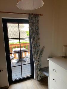 a sliding glass door with a view of a patio at B&B Oostkapelle aan Zee in Oostkapelle