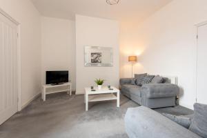 uma sala de estar com um sofá e uma televisão em Spacious 3-Bedroom Home, Newly Renovated, Sleeps 5 em Sunderland