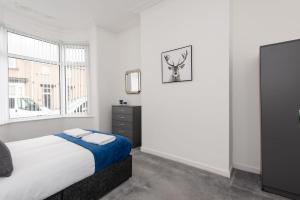 a white bedroom with a bed and a window at Spacious 3-Bedroom Home, Newly Renovated, Sleeps 5 in Sunderland