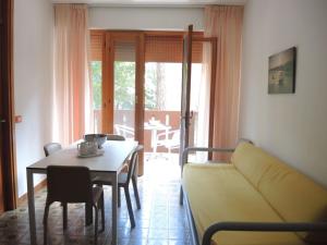 a living room with a couch and a table at Nice flat with terrace in a great spot - Beahost in Bibione