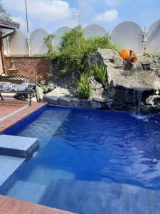 a swimming pool with a waterfall in a backyard at Air Luxury in Terzigno