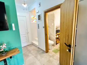 a small bathroom with a toilet and a door at Villa Stemily in Skala Rachoniou