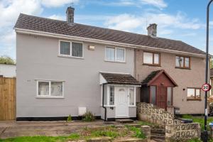 a white house with a red door at Super King Bed Free Parking Alexa Garden Patio BBQ Sleeps 6 in Avonmouth