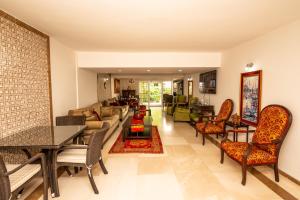 a living room with a couch and a table and chairs at 7 Art Feslegen Hotel By Egeos in Bodrum City