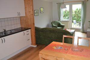 a kitchen and living room with a couch and a table at Haus Simone in Insel Poel