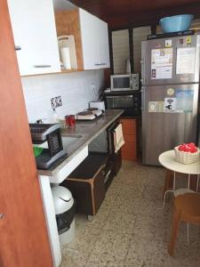 a kitchen with a refrigerator and a counter top at Studio Hadera in H̱adera